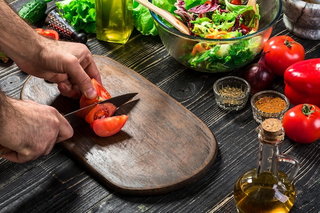 Hands preparing ingredients on wooden board